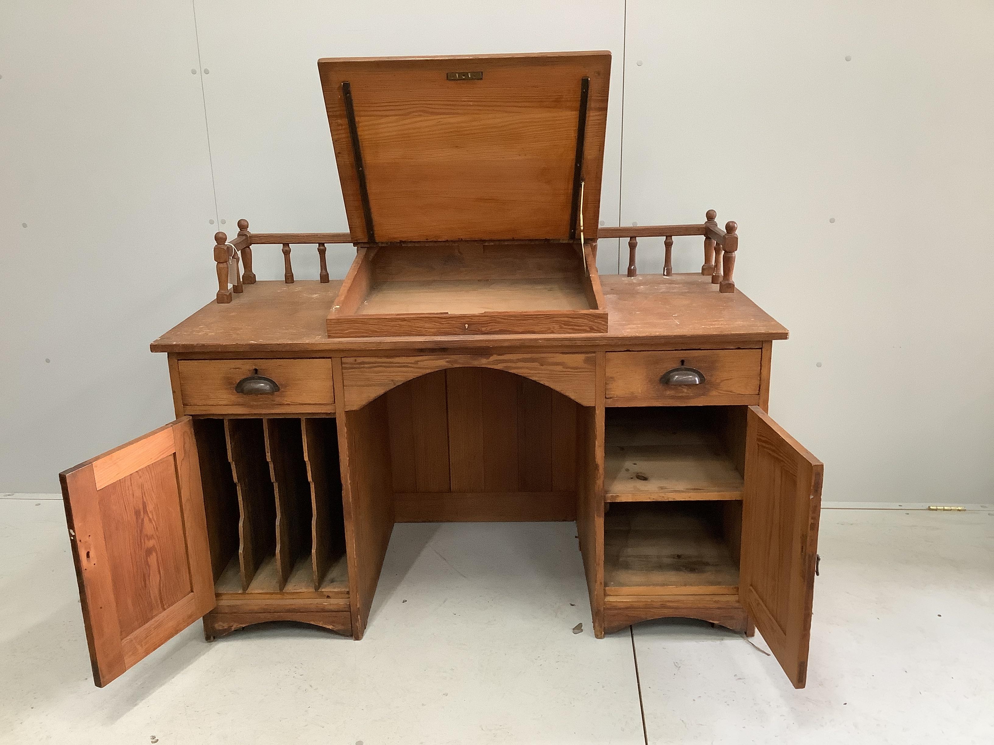 A late Victorian pitch pine kneehole desk, width 137cm, depth 67cm, height 93cm